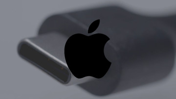 A USB-C connector in the background with an Apple logo on the front
